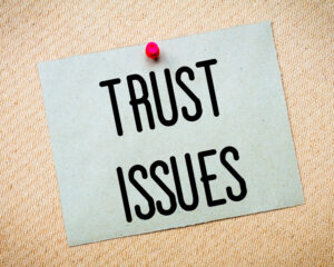 Recycled,Paper,Note,Pinned,On,Cork,Board.,Trust,Issues,Message.