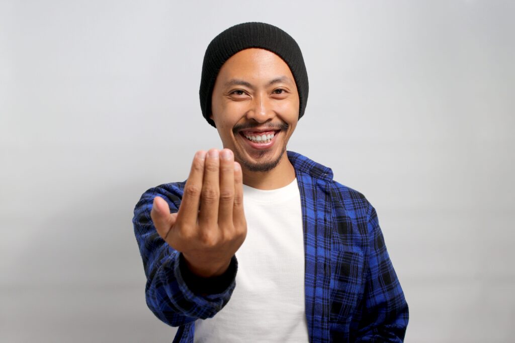 A man inviting someone to come join him