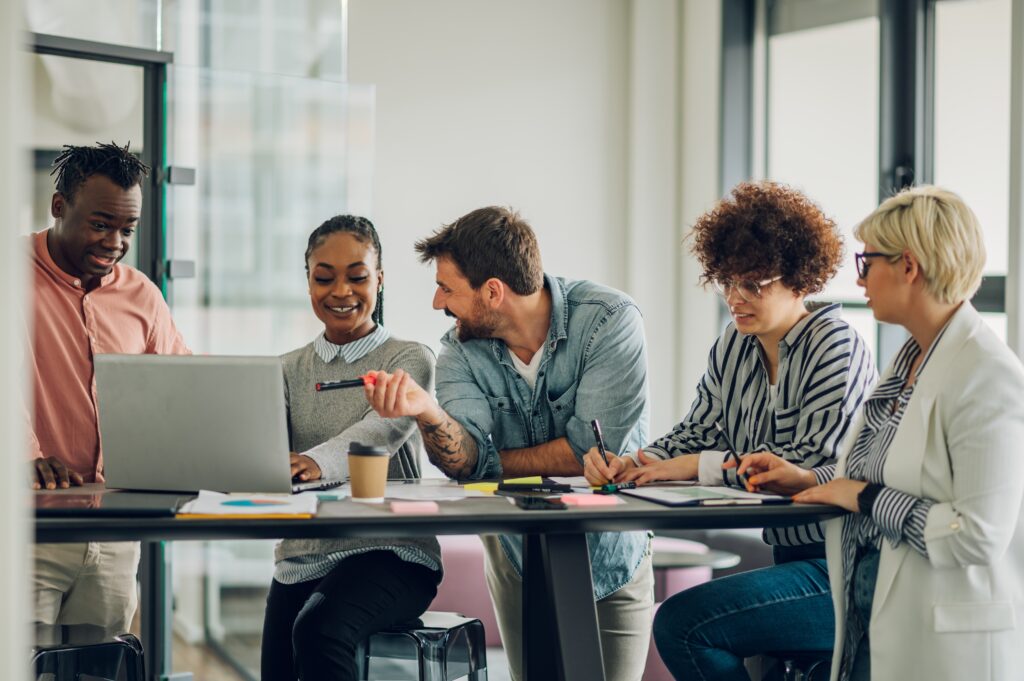 Team members enjoy conversation while working on a project